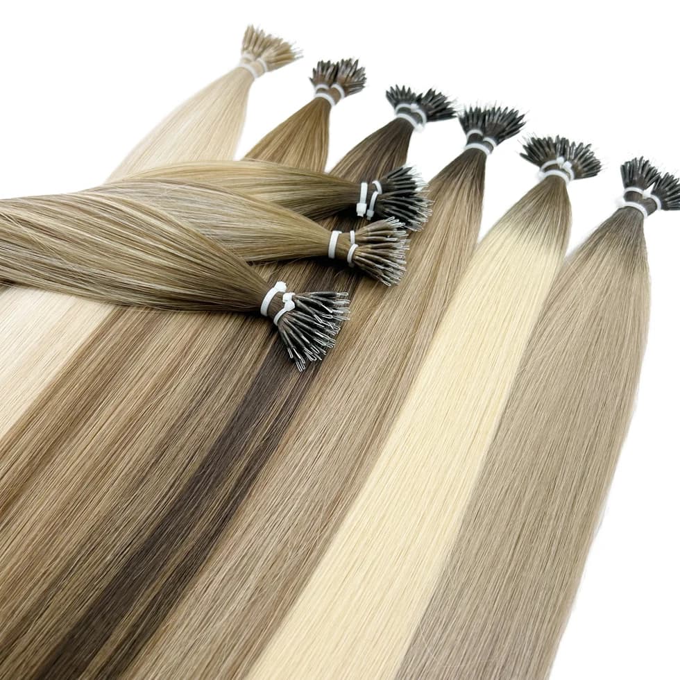 Nano Ring extension bundles in blonde and brown shades with small metal loop attachments visible