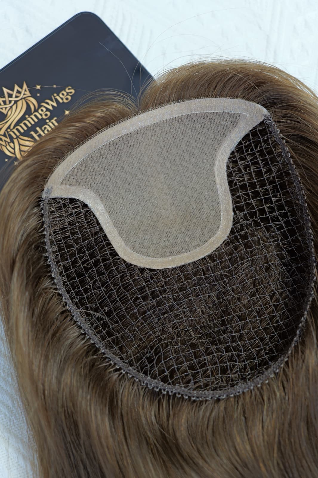Close-up of a brown fishnet topper base with a front panel and breathable mesh