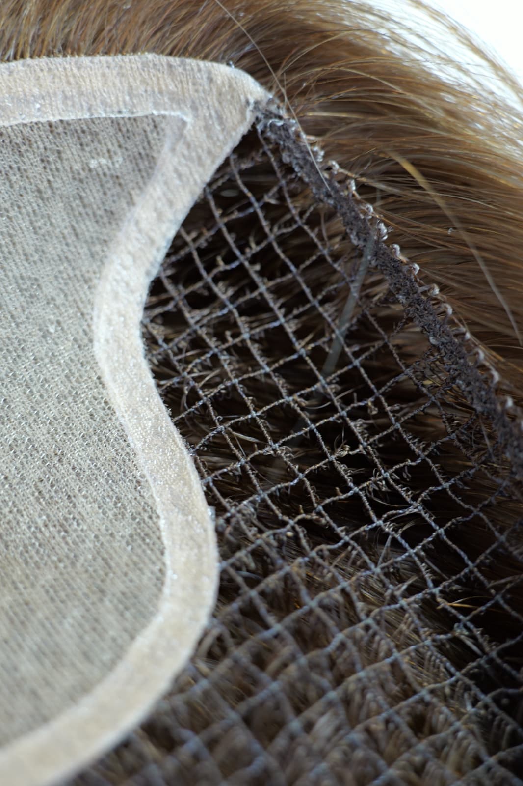 Fishnet topper construction detail showing the mesh base and front panel boundary