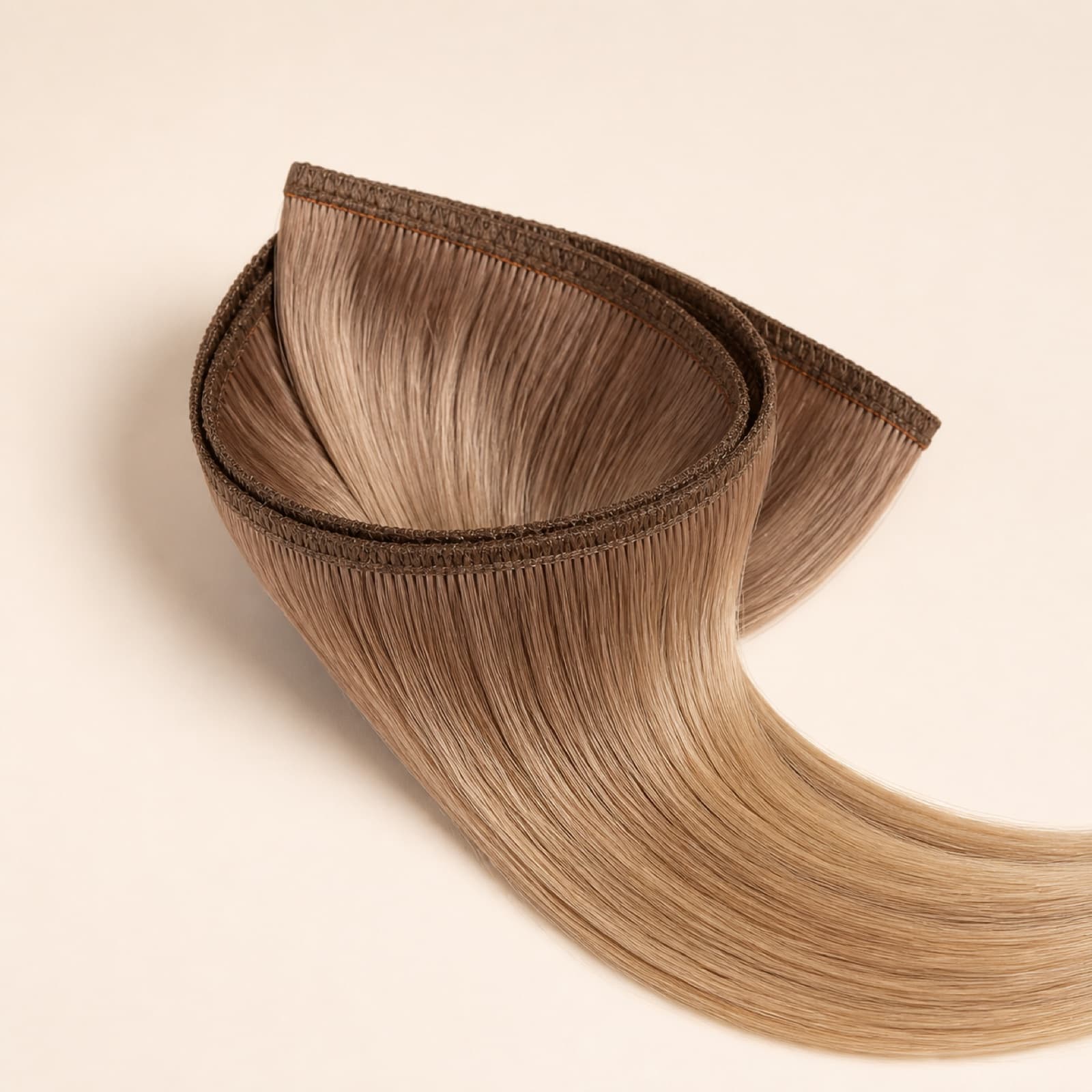 Flat Weft virgin human hair extension with a reinforced flexible seam