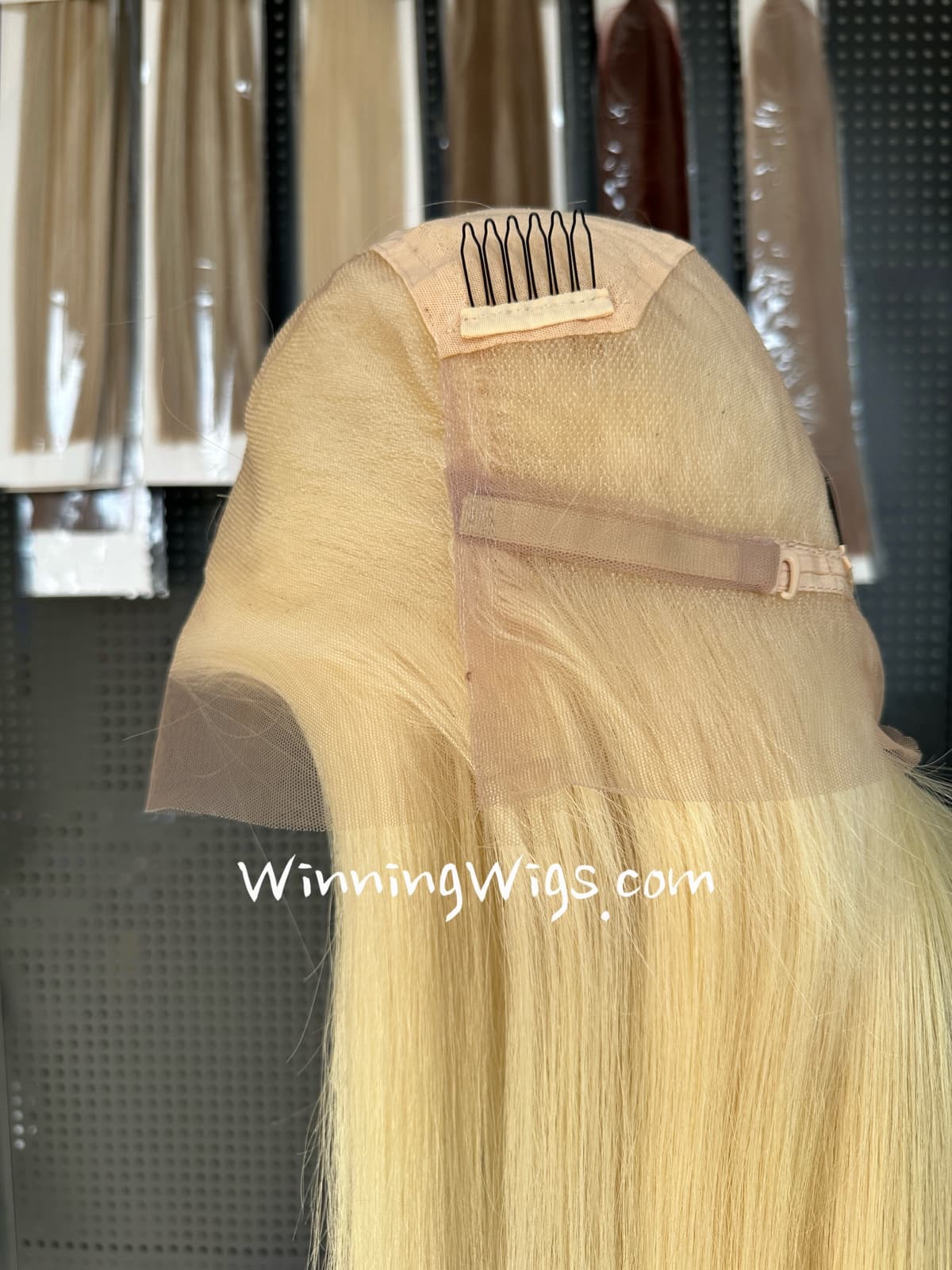Interior of a blonde HD full lace virgin human hair wig with an adjustable strap and comb