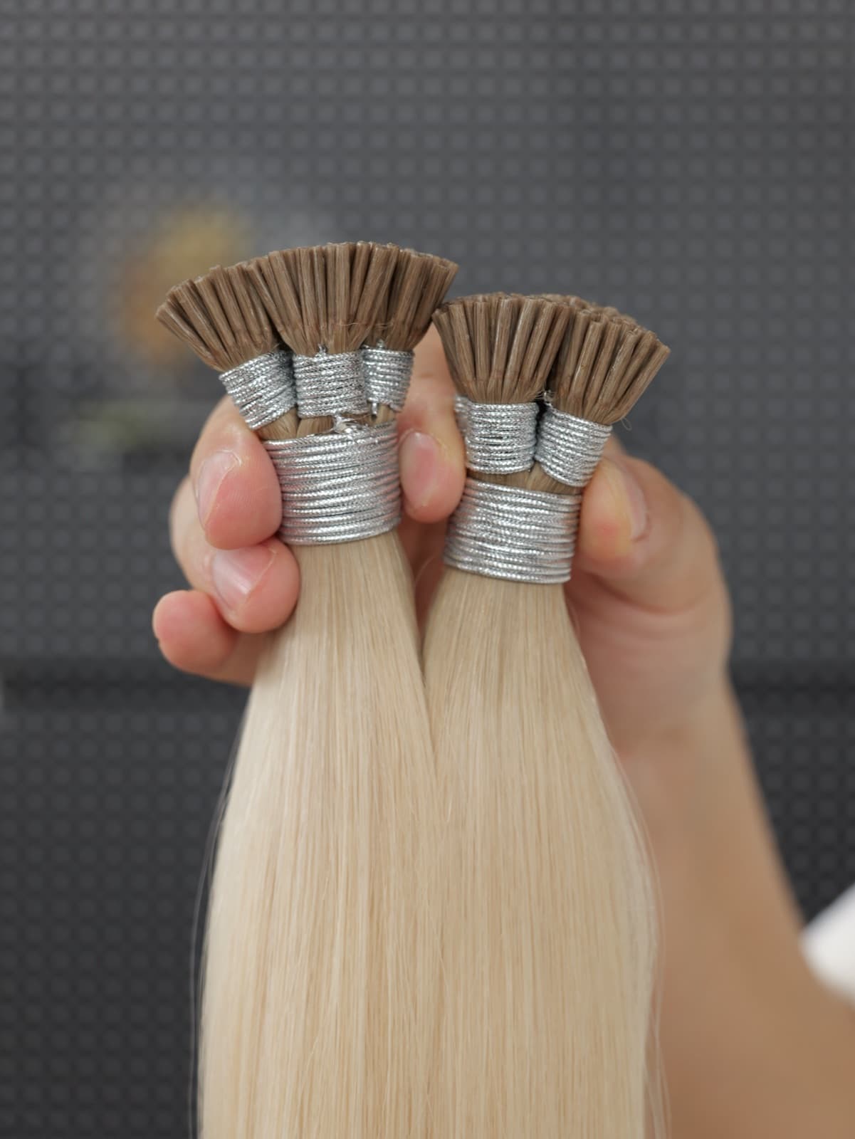 Close-up of light blonde I Tip human hair extension keratin bonds