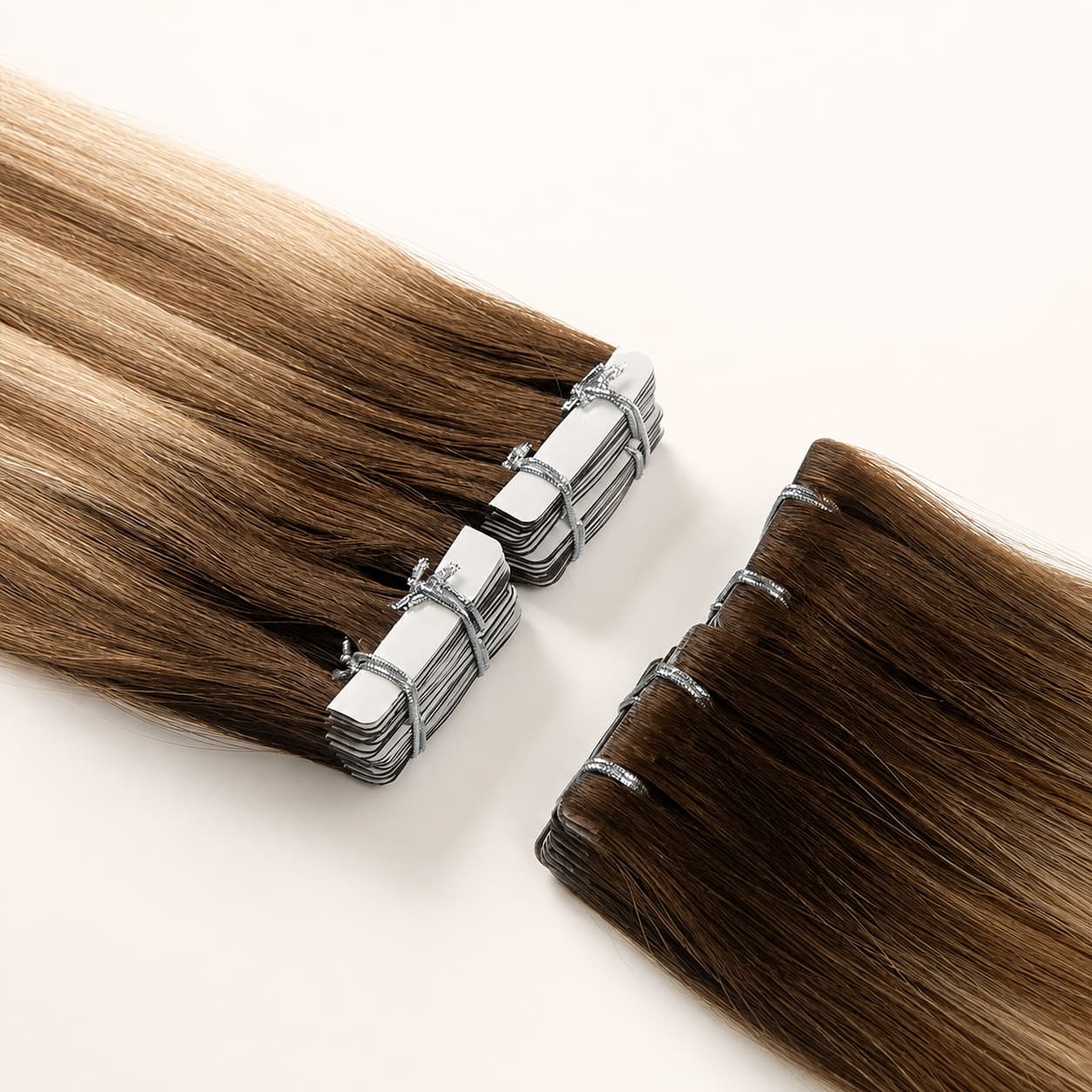 Invisible tape-in human hair extensions showing the adhesive tape tab construction