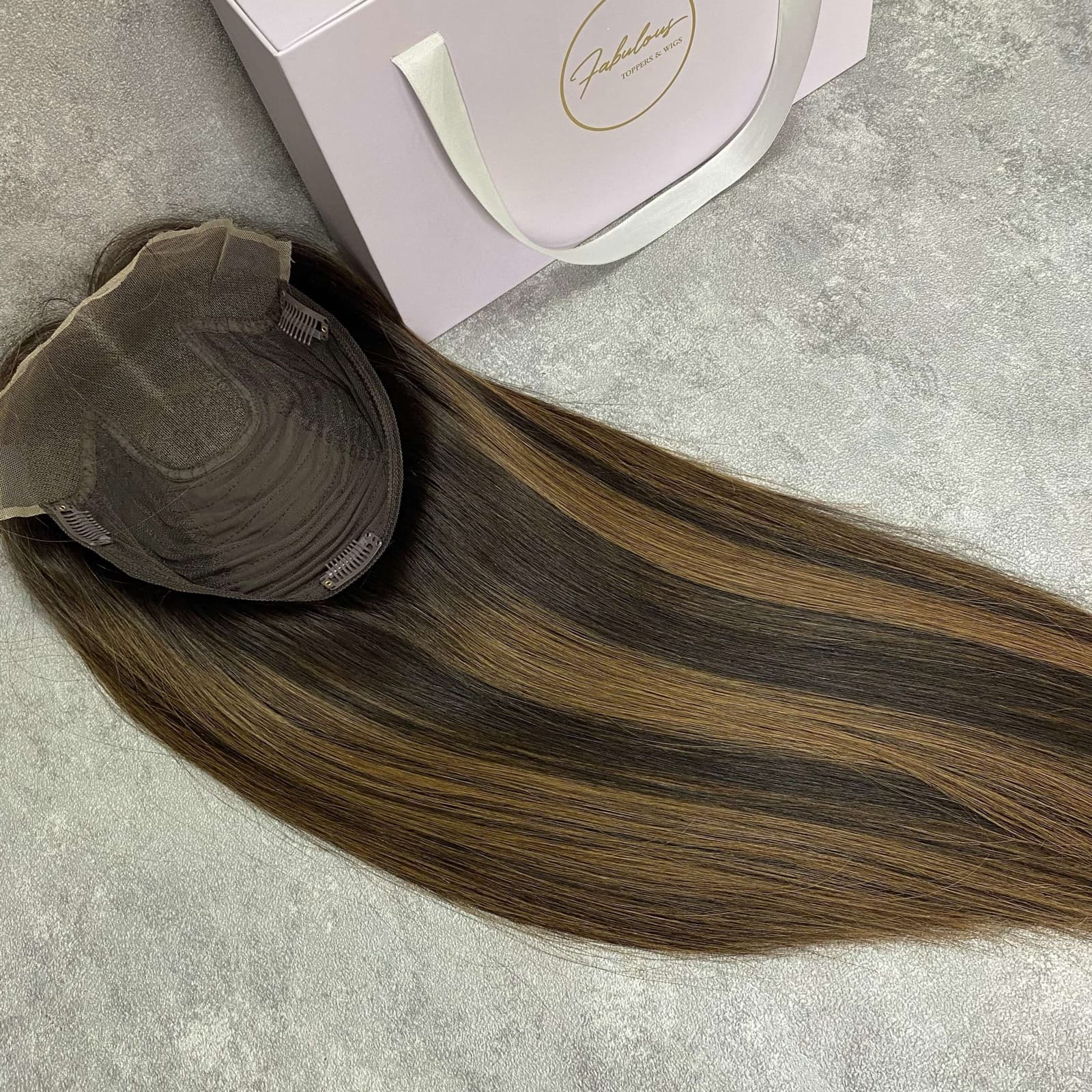 Brown lace topper showing the cap construction and long straight hair length