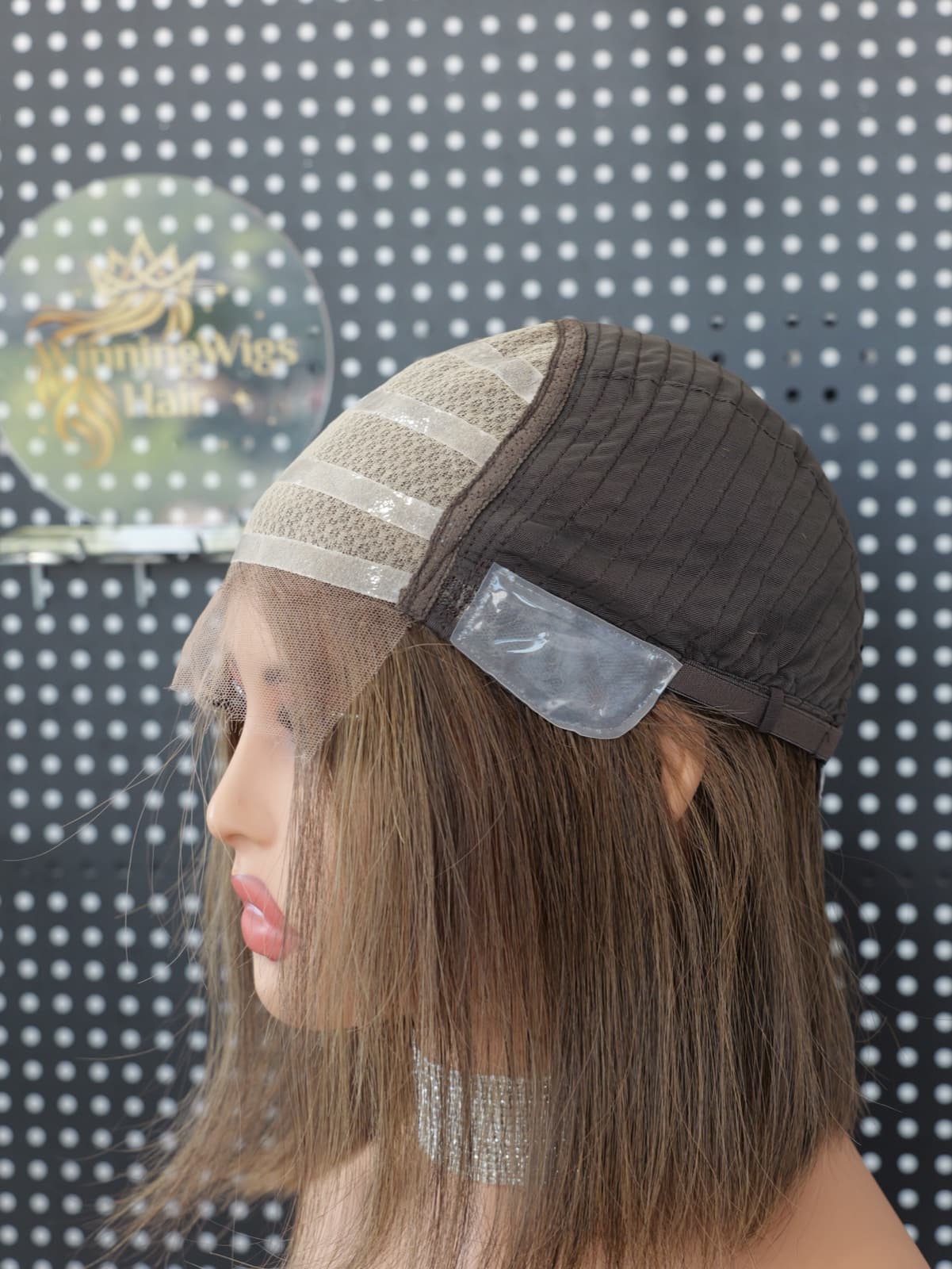 Medical human hair wig cap construction with a lace front and silicone grip panel