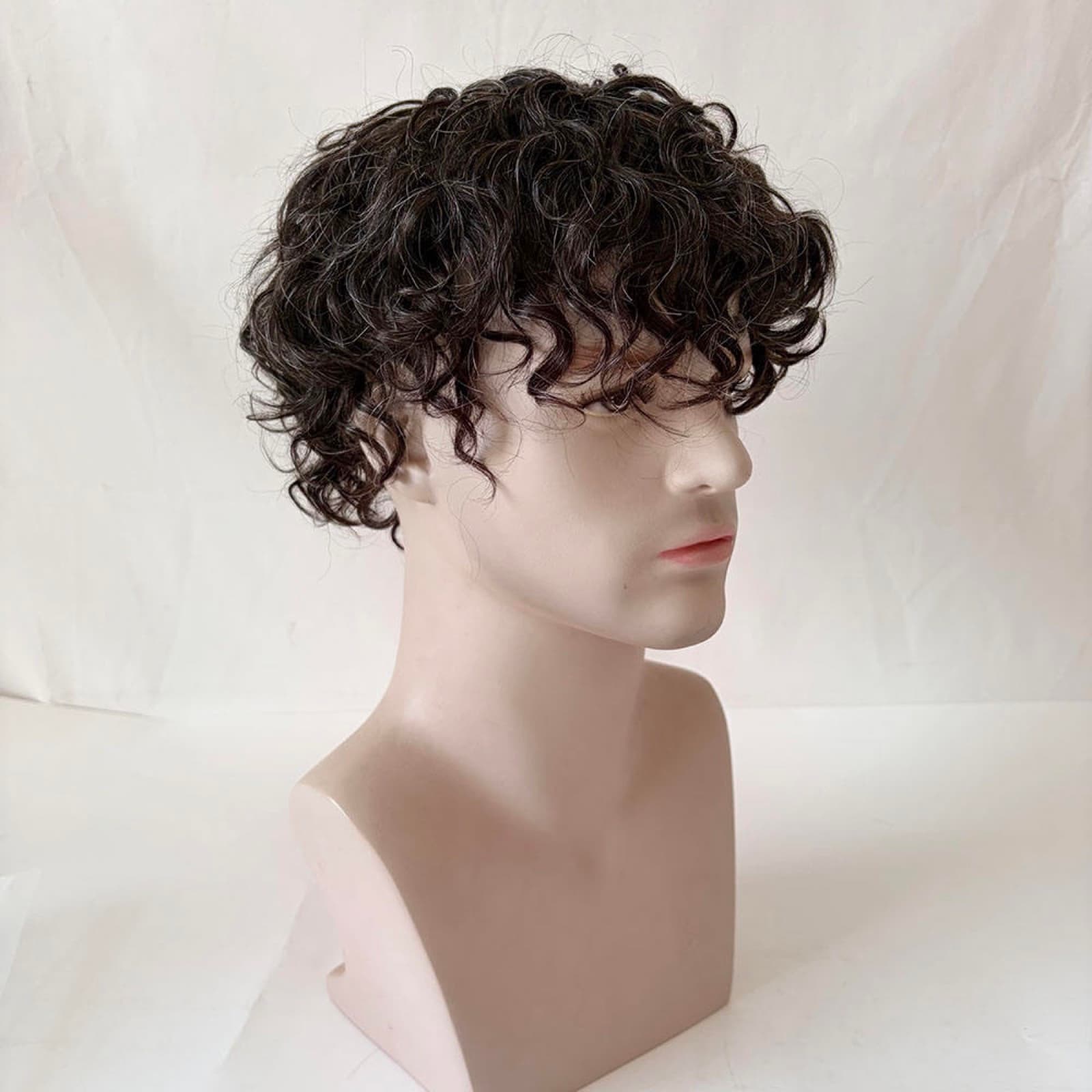 Curly men's hair system styled on a mannequin