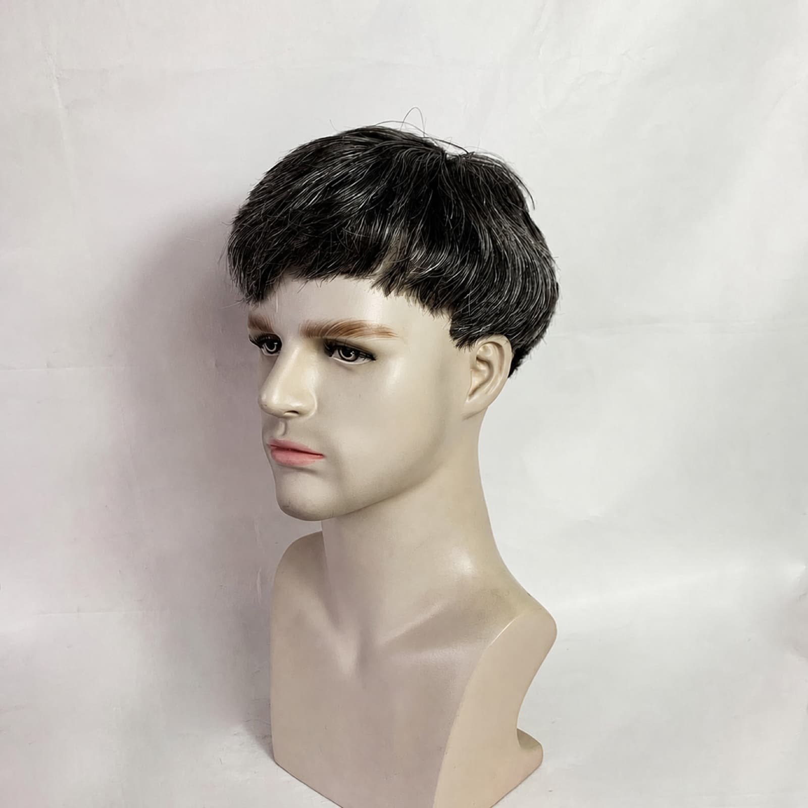 Short black men's hair system styled on a mannequin