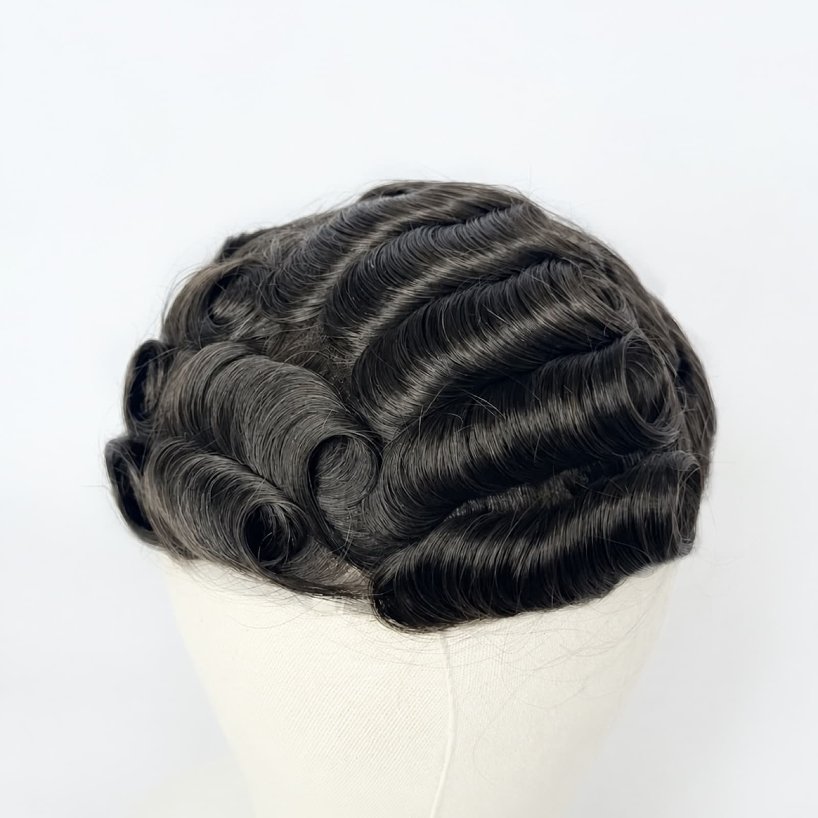 Black wavy men's hair system displayed on a mannequin