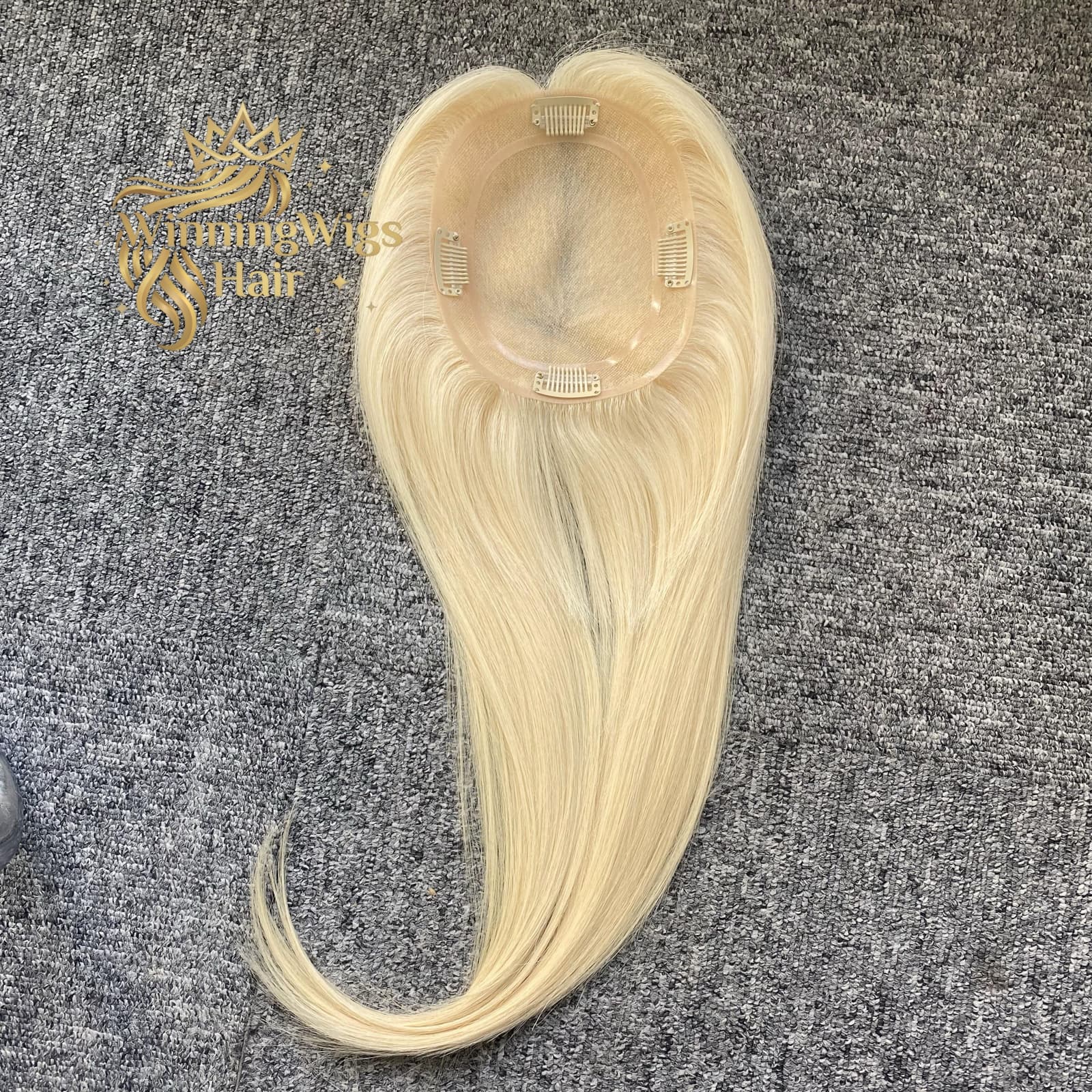 Blonde mono topper base with four pressure clips and long straight hair