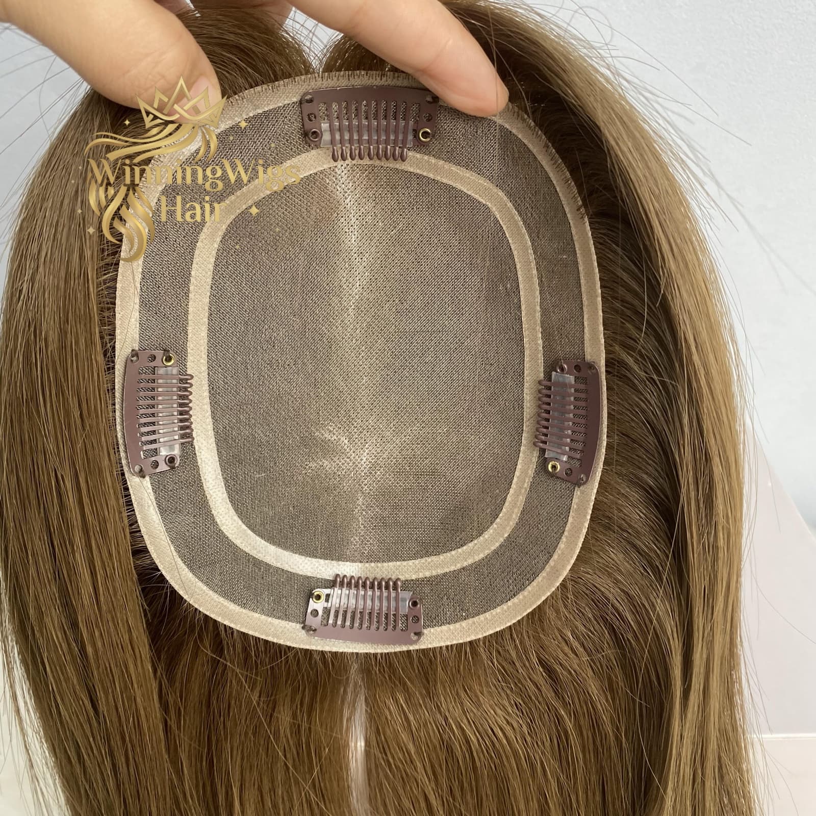 Brown mono topper base close-up with four pressure clips