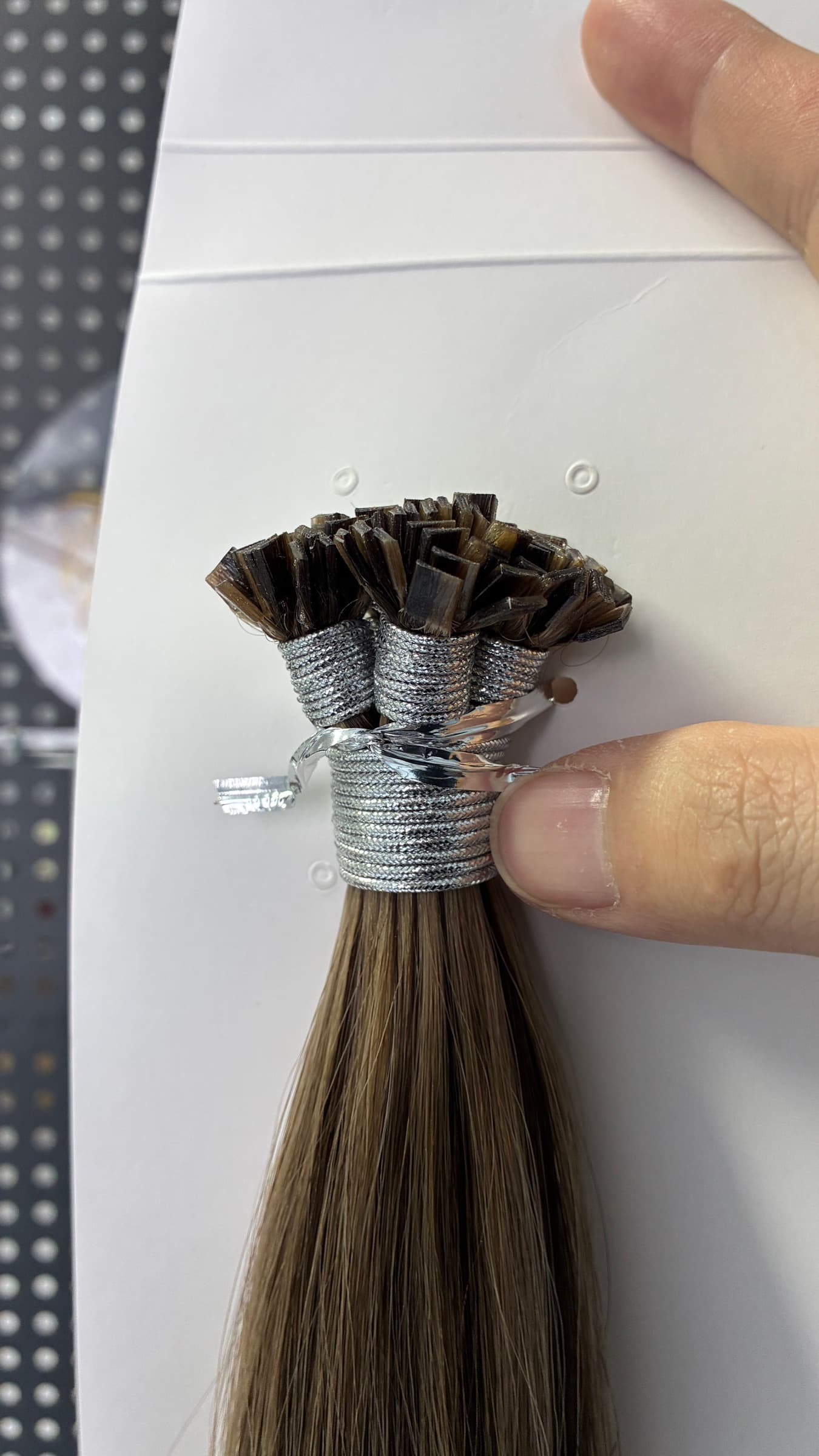 Close-up of dark Flat Tip keratin bond ends