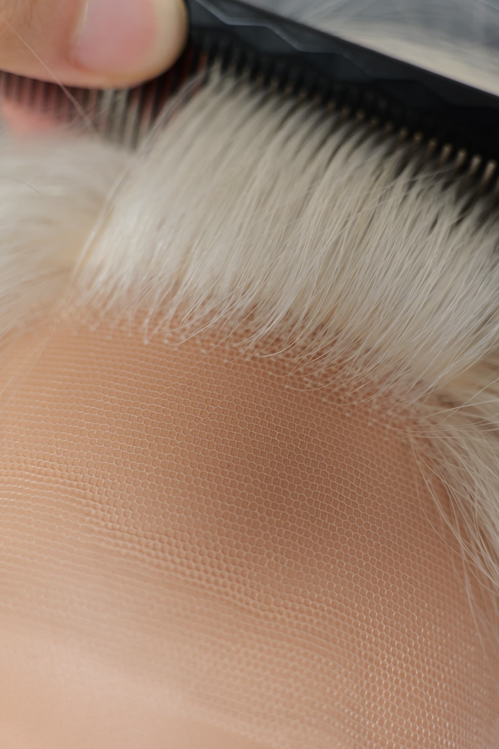 Close-up of fine HD lace and hairline on a blonde human hair wig