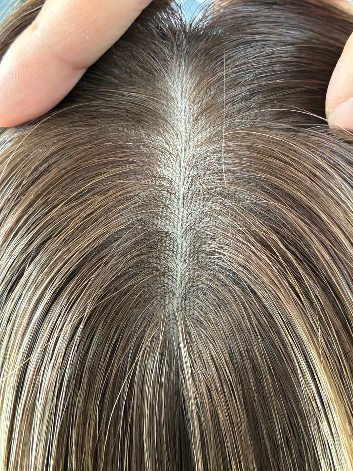 Brown silk topper centre part detail showing the silk base beneath the hair