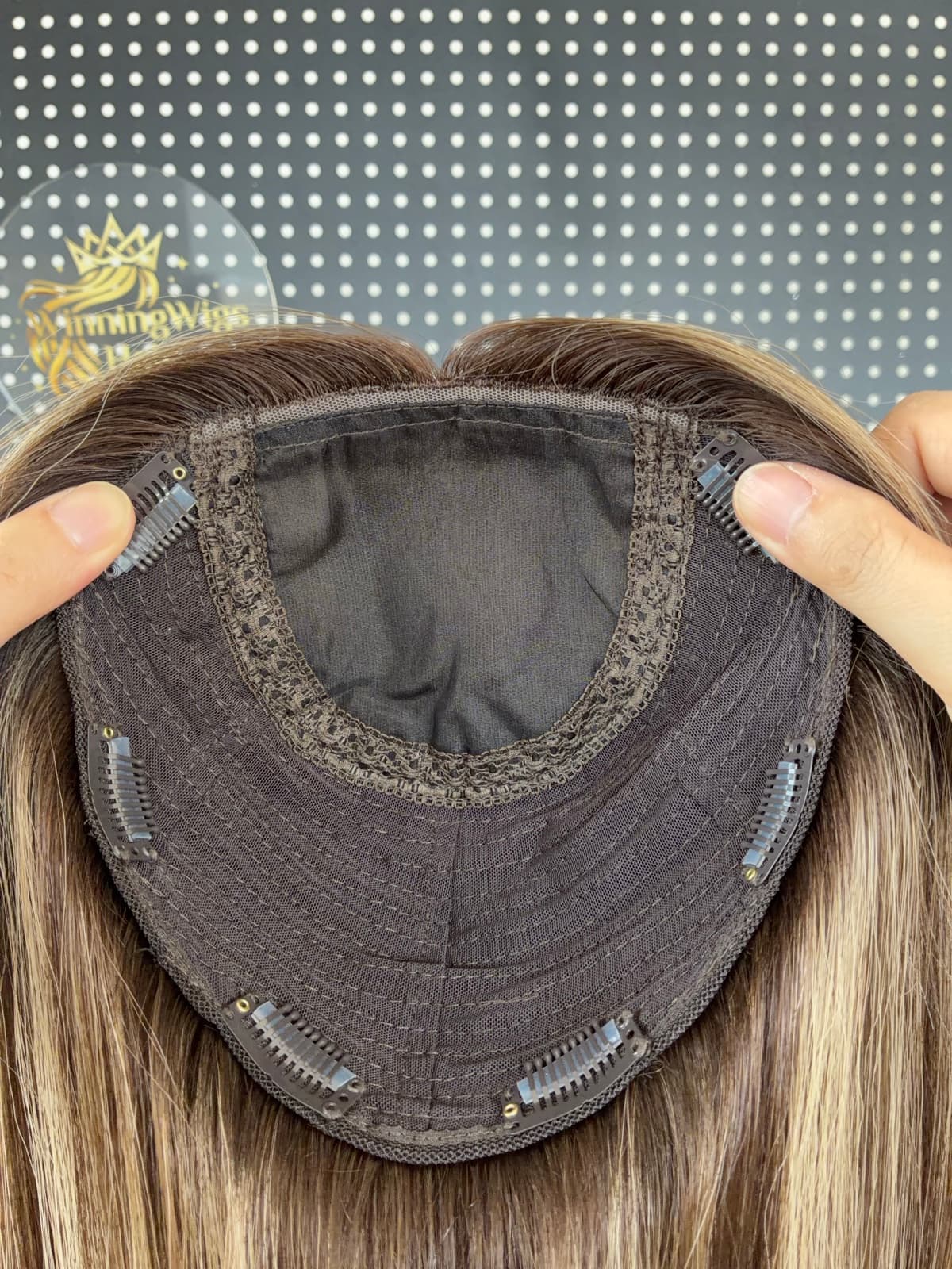 Brown silk topper cap close-up showing the silk base and pressure clips