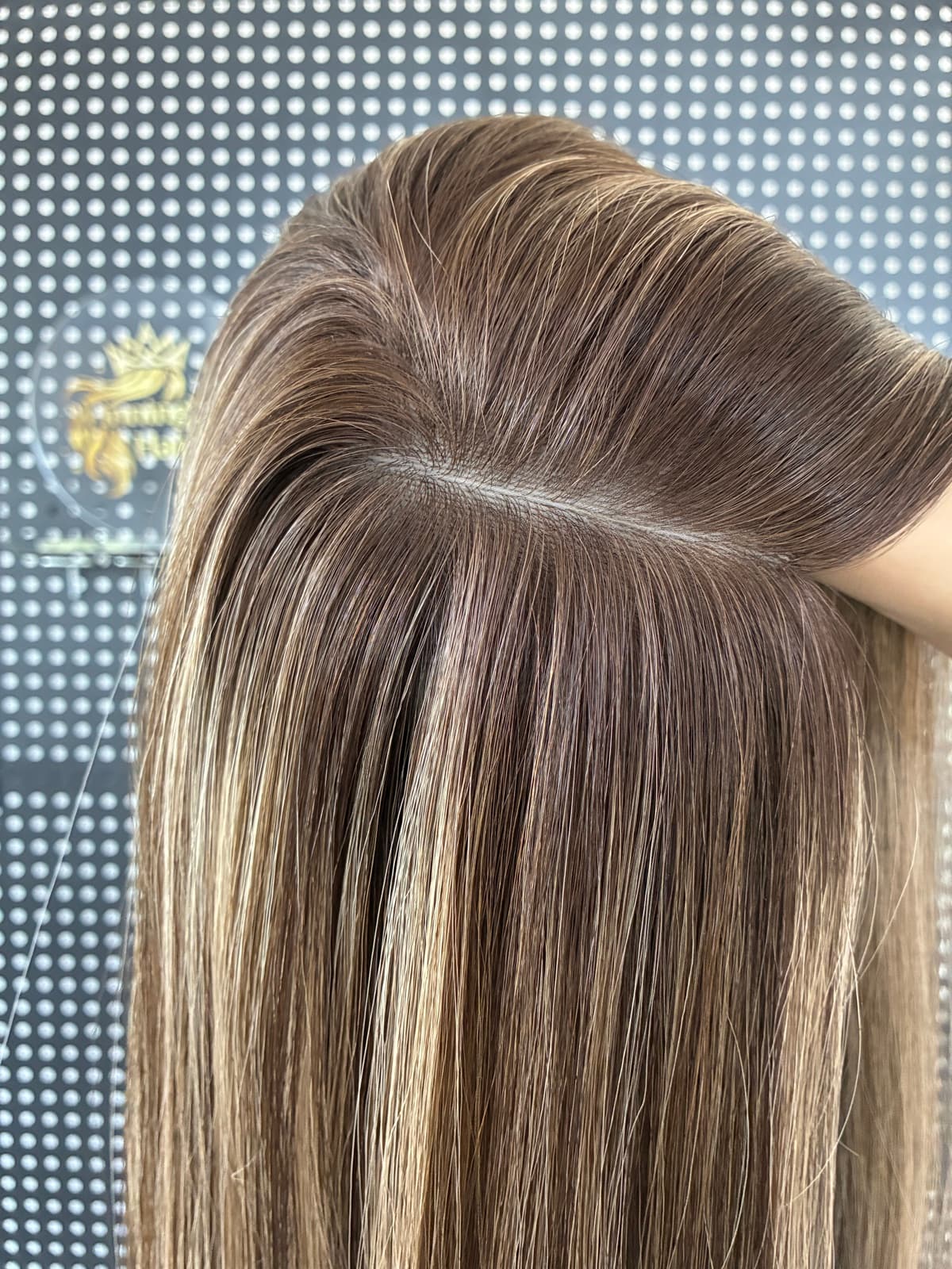 Brown silk topper parting detail showing hair distribution at the silk base