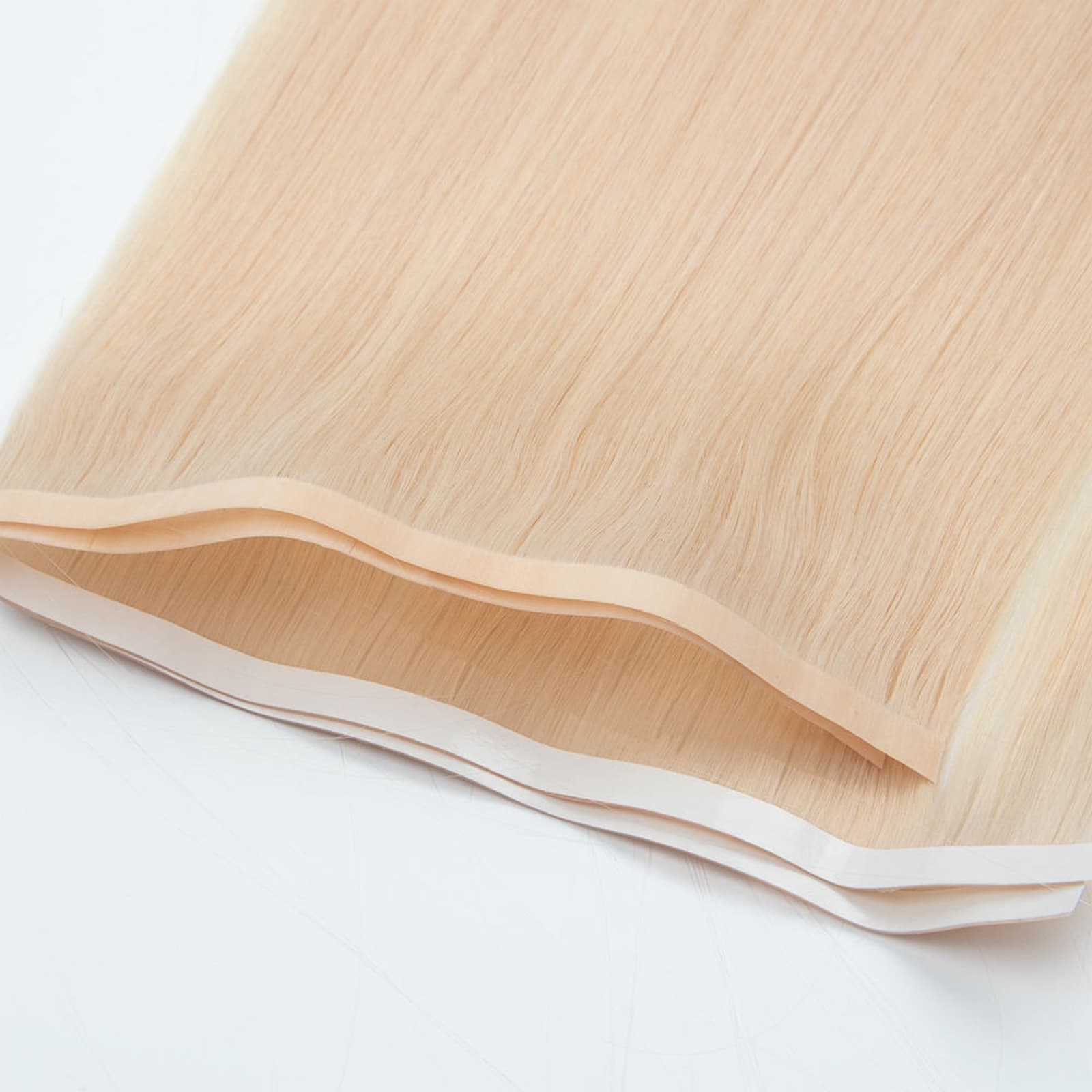 Light blonde Tape Weft Extensions with low-profile reinforced seams