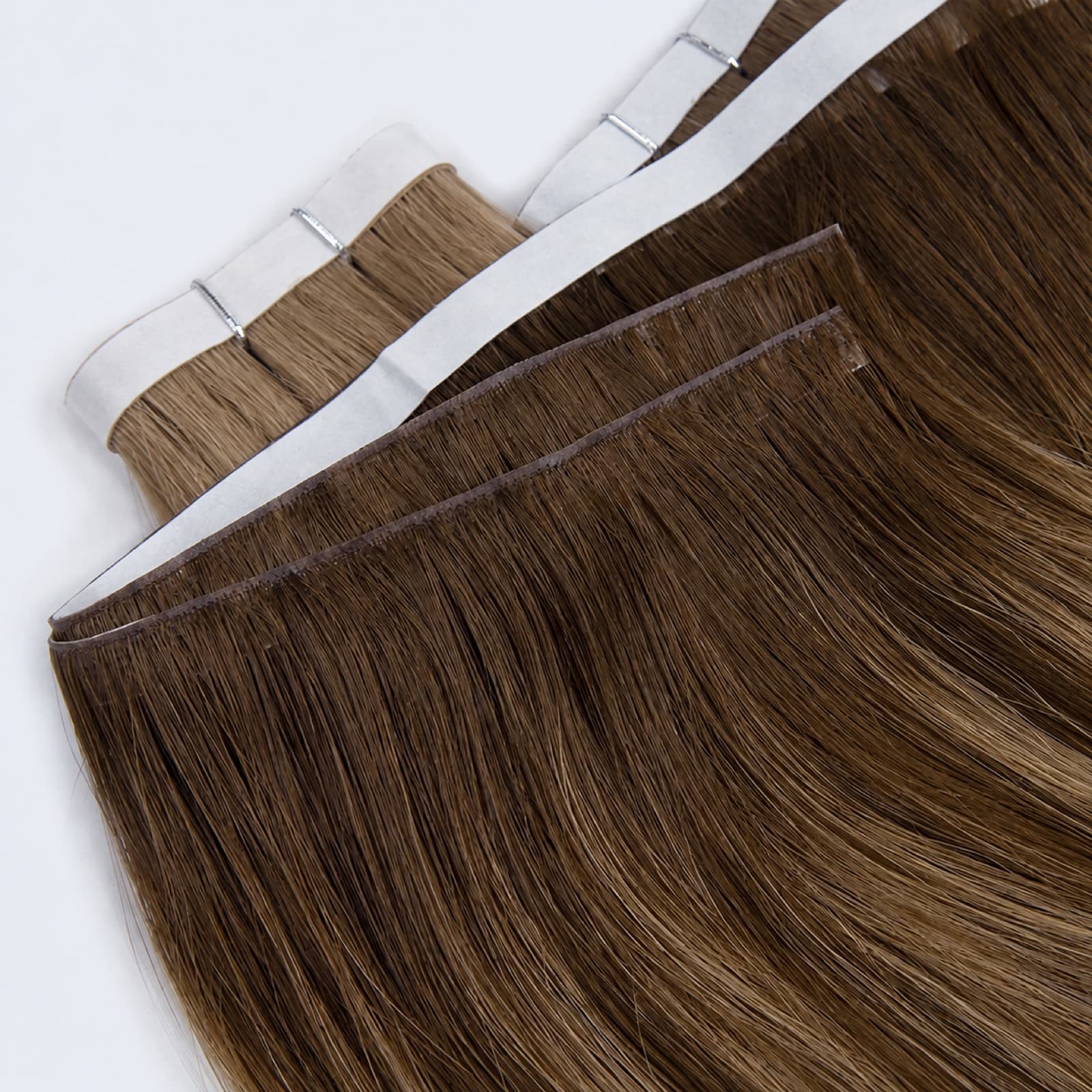 Dark brown Tape Weft Extensions showing reinforced seam construction