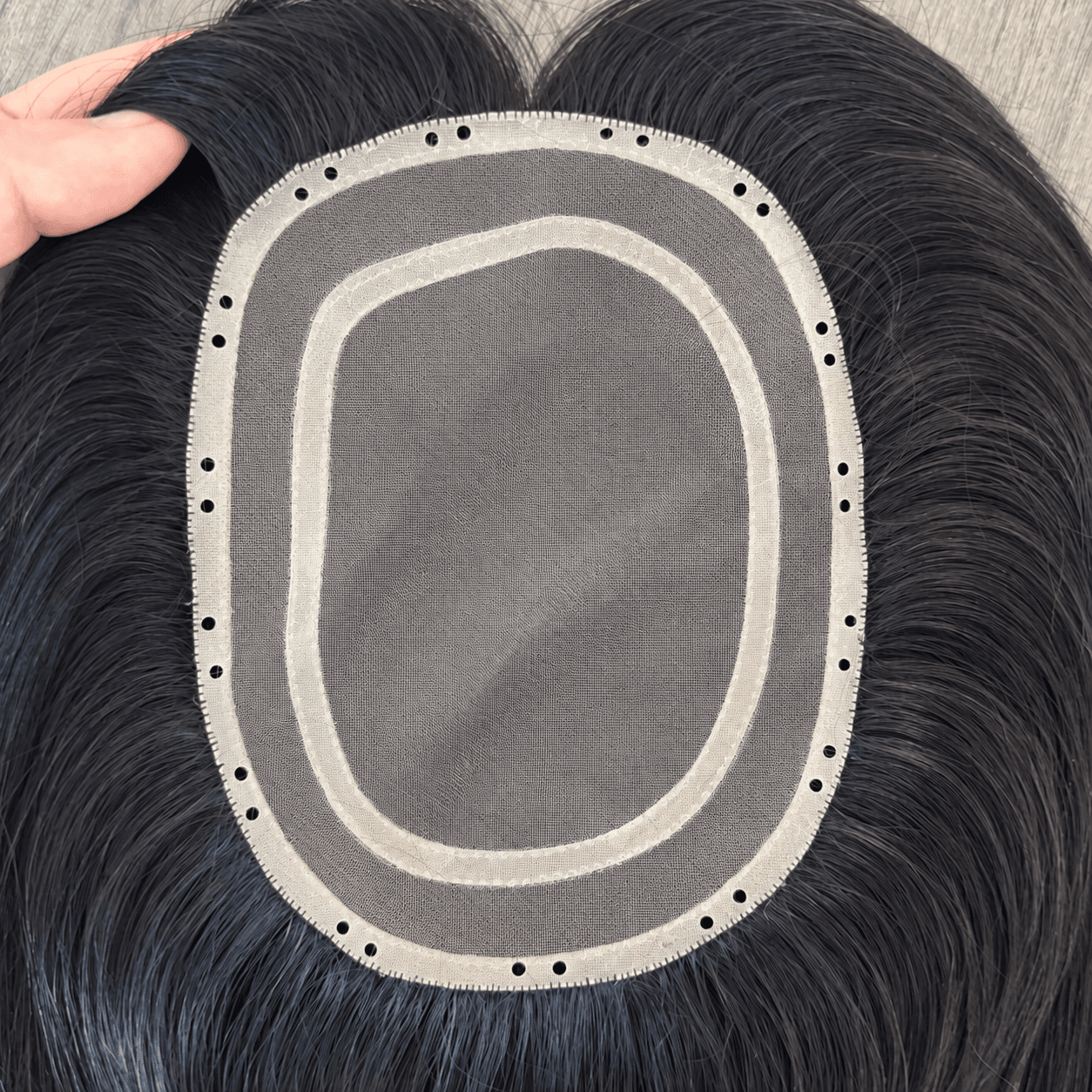 Black Bead-In Mono Topper underside showing the mono lace center, PU perimeter and attachment holes