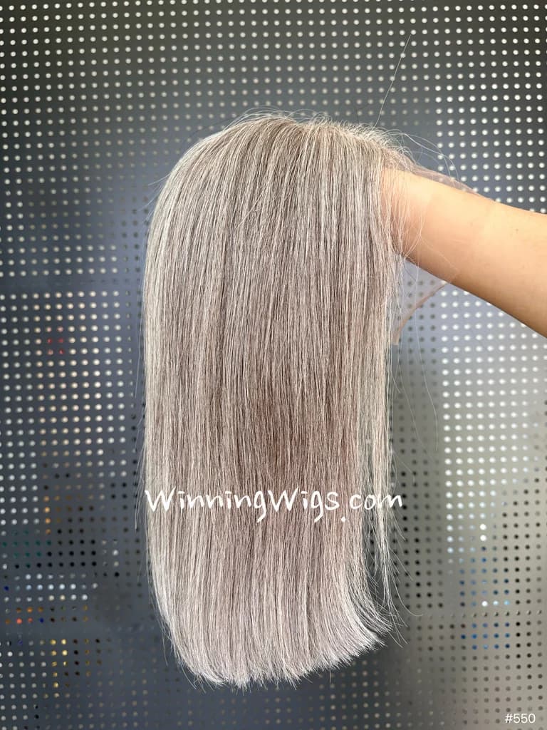 Straight gray hairpiece displayed over a hand with a WinningWigs.com watermark and a visible number 550 label