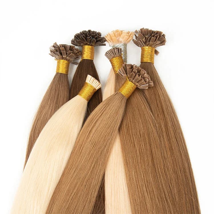 Flat-tip hair extension bundles in blonde and brown shades arranged on a white background