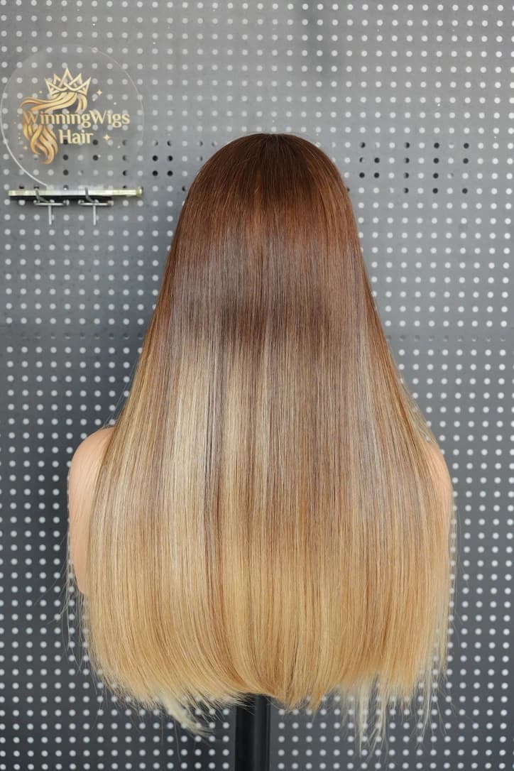 Rear view of a straight brown-to-blonde wig showing the color transition and the shape of the ends