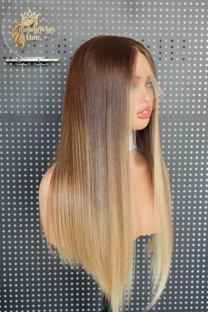 Long straight brown-to-blonde wig on a mannequin, viewed from the side with the front lace visible
