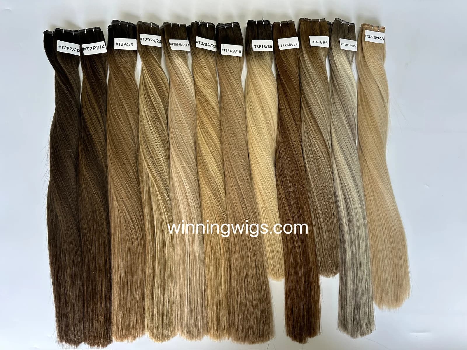 Labeled straight human hair extension weft samples in brown and blonde shades