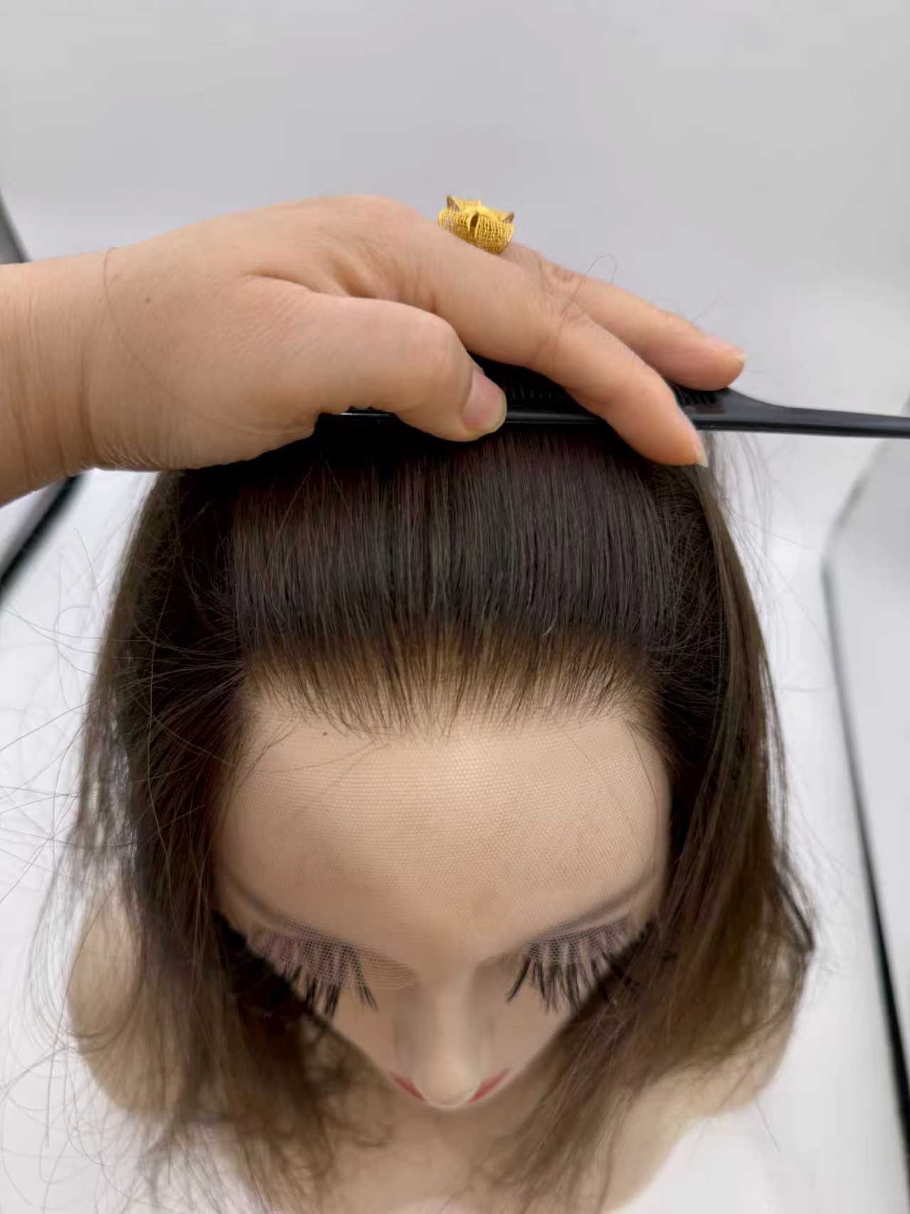 Close-up of an Invisible Hairline wig showing the front hairline and lace